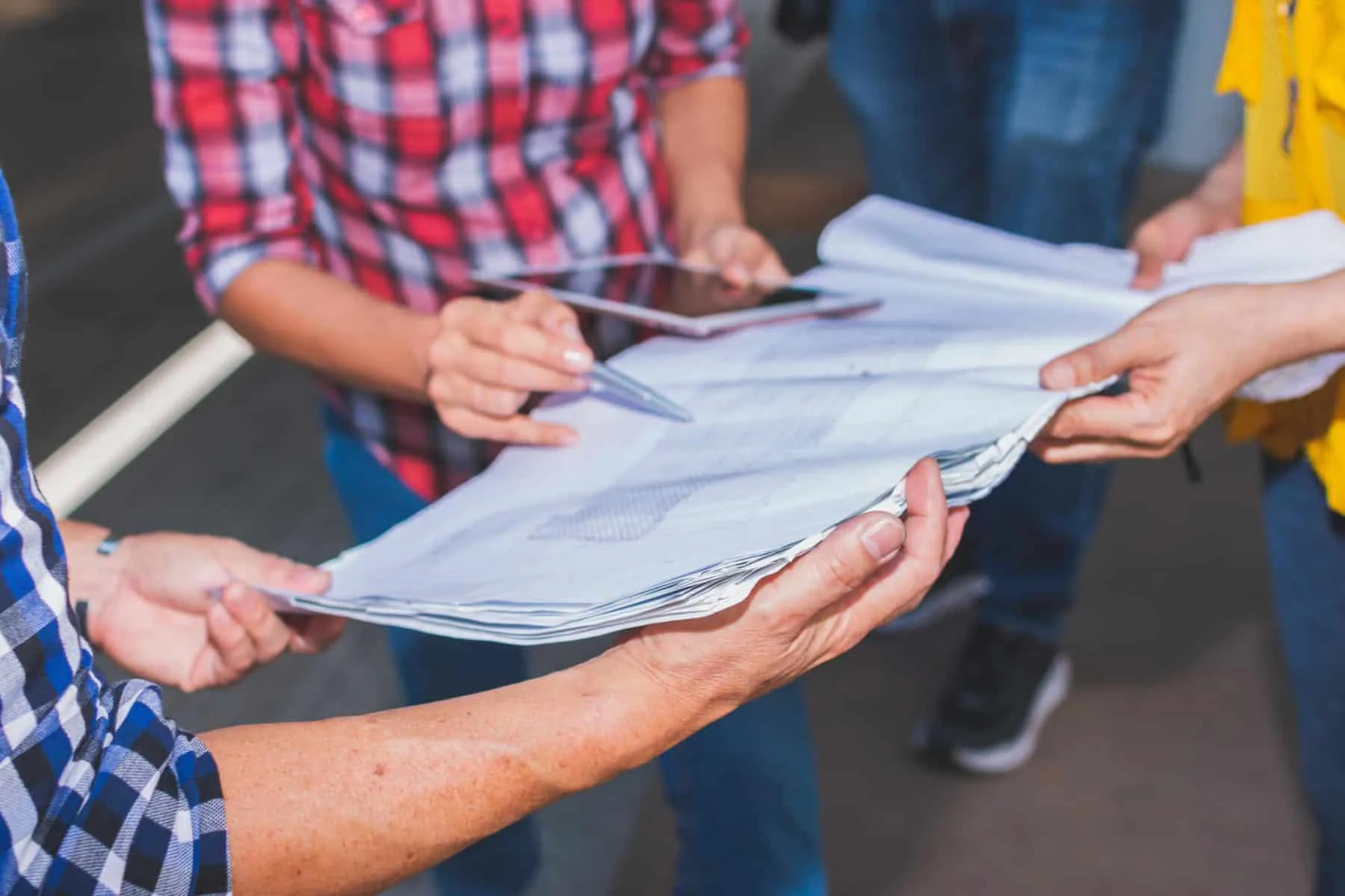 Close up of hand engineer meeting for architectural project working with partner and engineering tools on workplace. | ISG INVESTS IN THE DES MOINES COMMUNITY WITH NEW OFFICE LOCATION