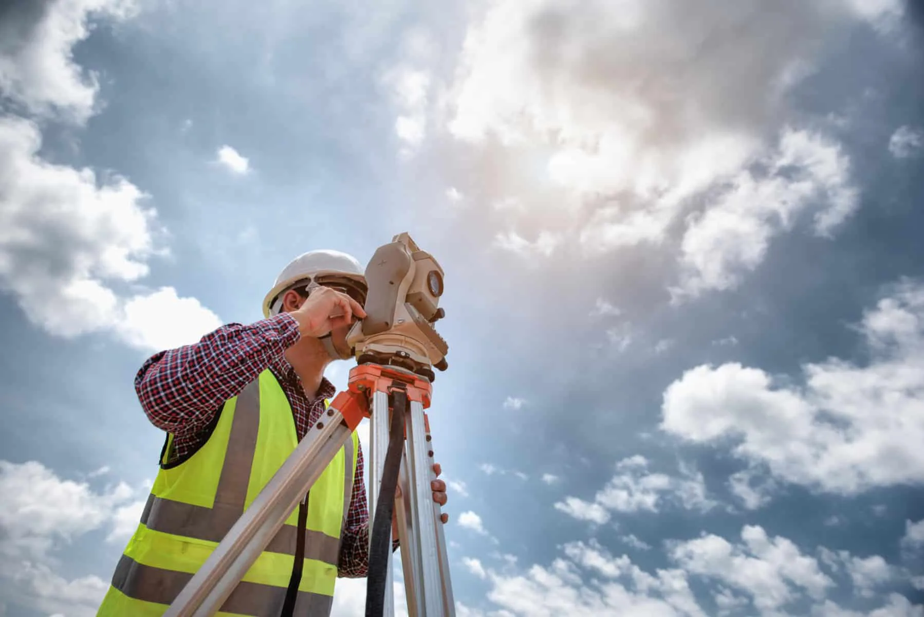Surveyor equipment. Surveyor’s telescope at construction site or Surveying for making contour plans are a graphical representation of the lay of the land before startup construction work | COLLIERS ENGINEERING & DESIGN AQUIRES KFW ENGINEERS + SURVEYING