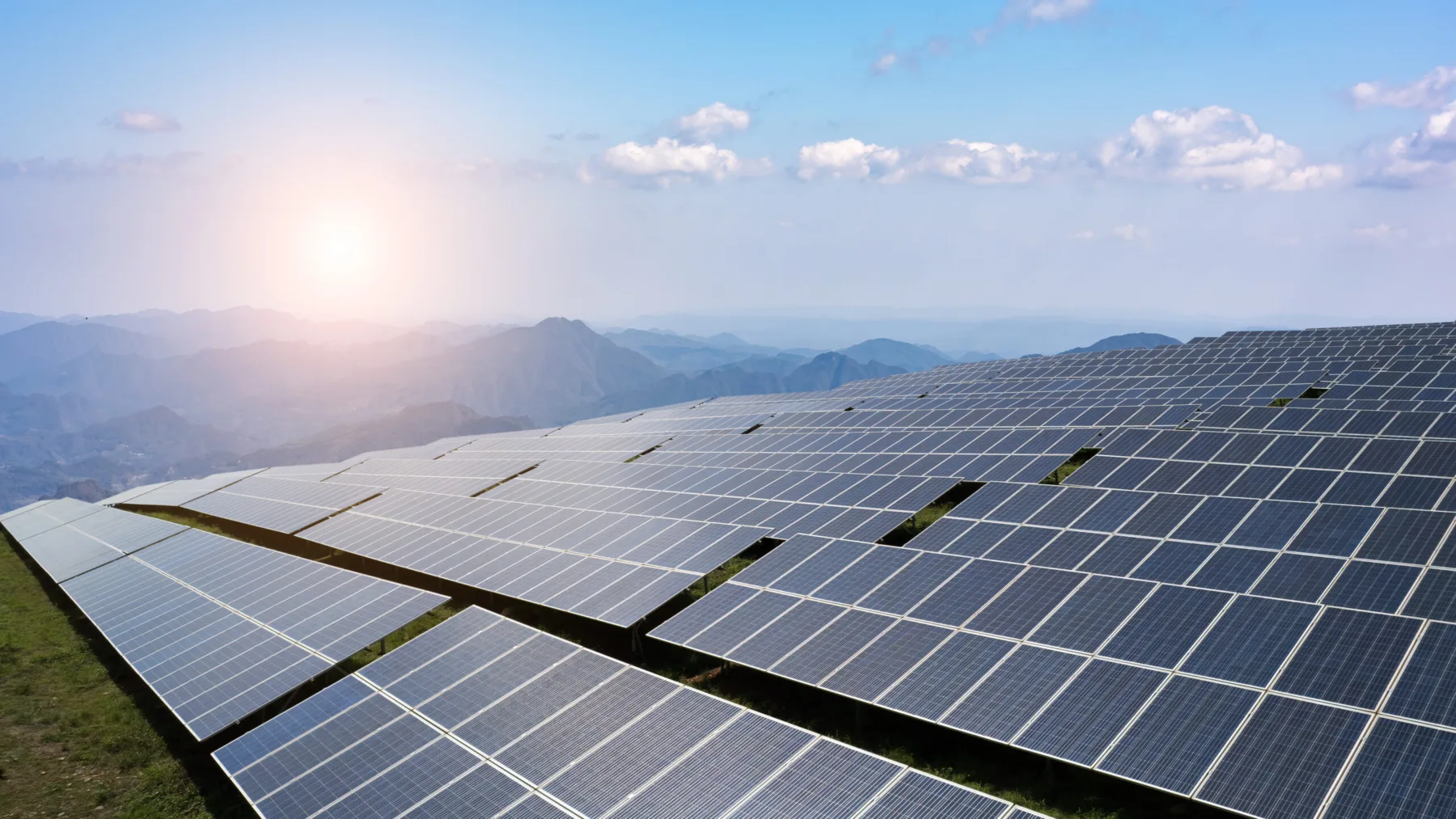Captivating Solar Panel Field Overlooking Majestic Mountain Landscape | Arcadis joins forces with Schneider Electric and energy solution providers to accelerate resilient infrastructure